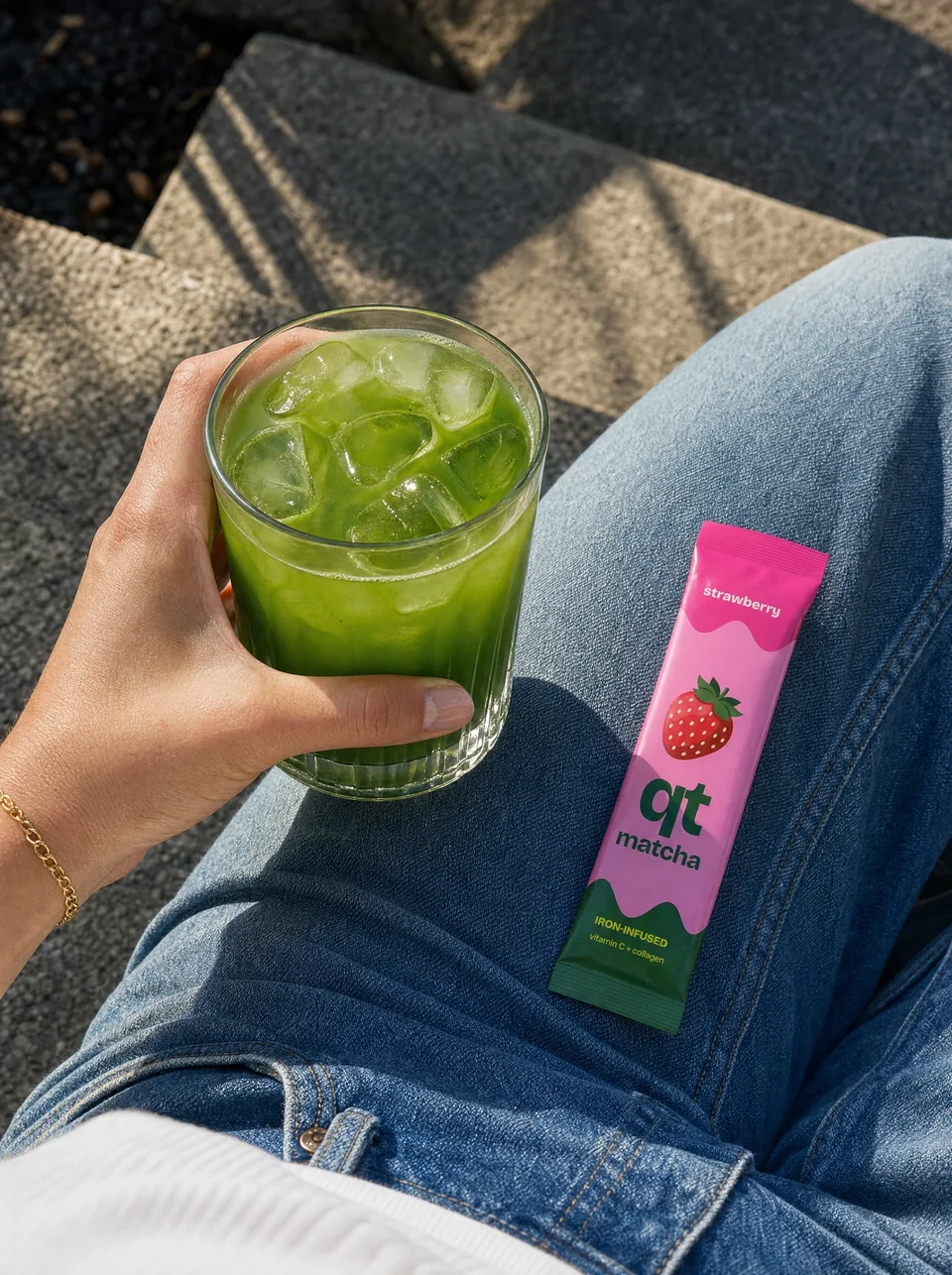 Iced matcha and a Strawberry QT packet in the sunshine